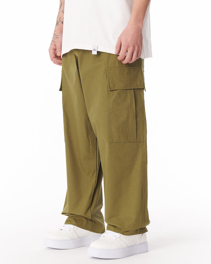 Martin Valen khaki wide-leg trousers full front view, adjustable cuff visible with white sneakers at hem