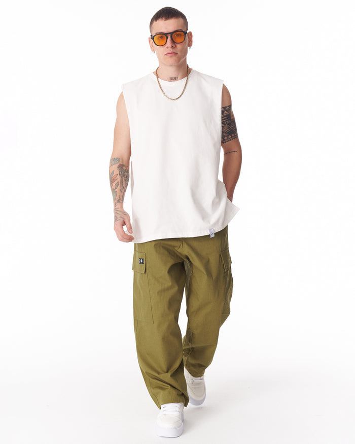 Martin Valen khaki wide-leg trousers worn, rear three-quarter view showing cuff and white sneakers