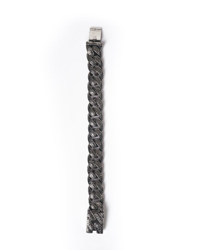 Martin Valen heavy stainless steel bracelet, top-down vertical view, twisted engraved links with floral motifs and clasp