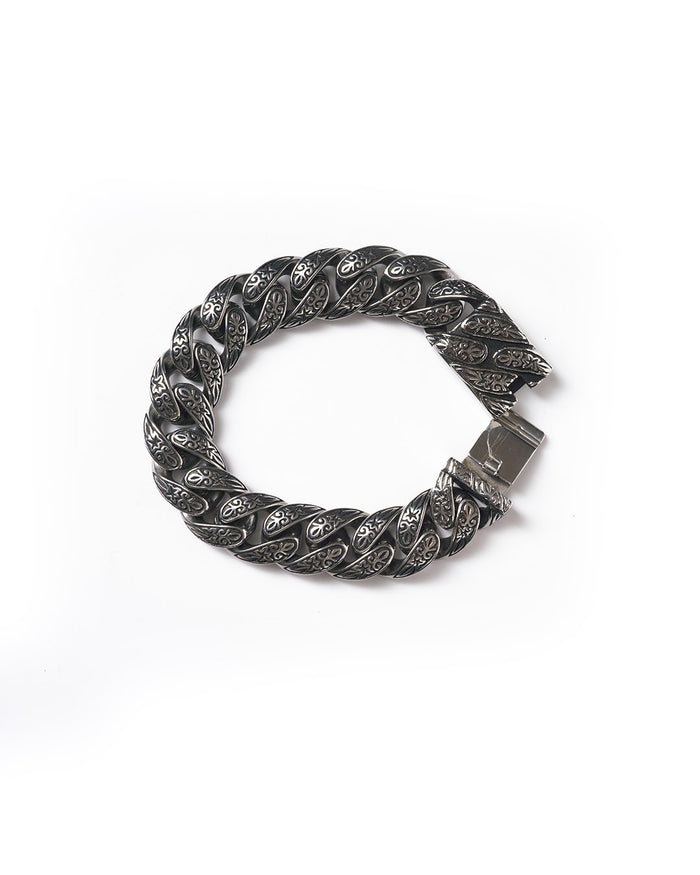 Martin Valen engraved heavy stainless steel bracelet, flat circular top view, wide twisted links with floral engraving and clasp