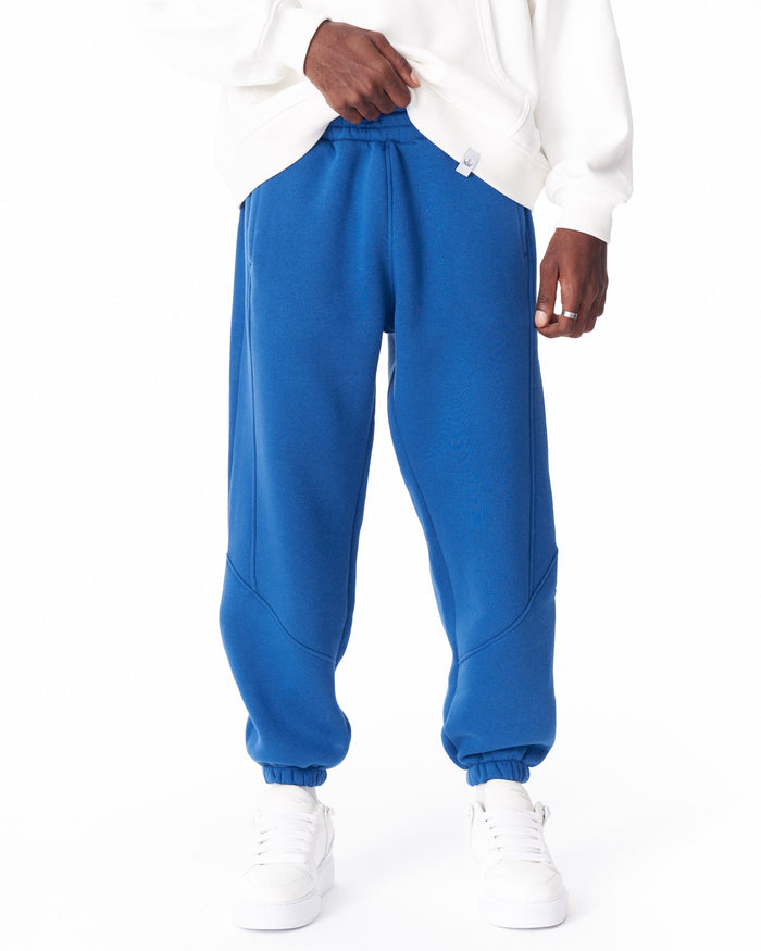Martin Valen blue joggers, full front view showing raised stitch seams, elastic waistband and white hoodie contrast