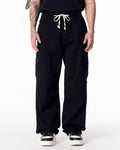 Martin Valen men's oversize black cargo jogger pants, front waist view with white drawstring tied and side pockets